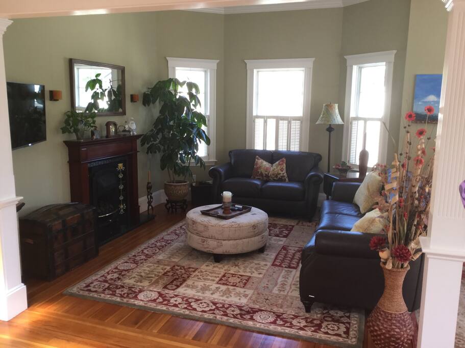 Warm and cozy living room with leather couch, gas fireplace and tv. Our home has many windows so it gets great light