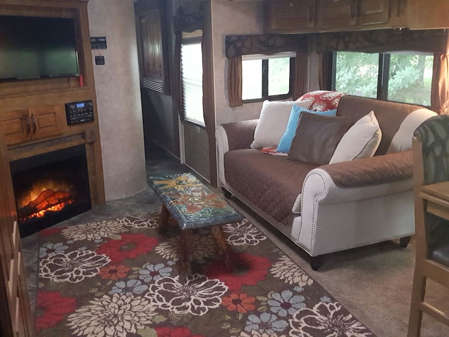 living room with upgraded love seat, fireplace, and tv