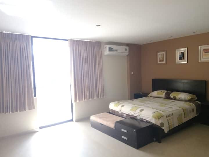 Bedroom 1 with split A/C and door to Balcony area