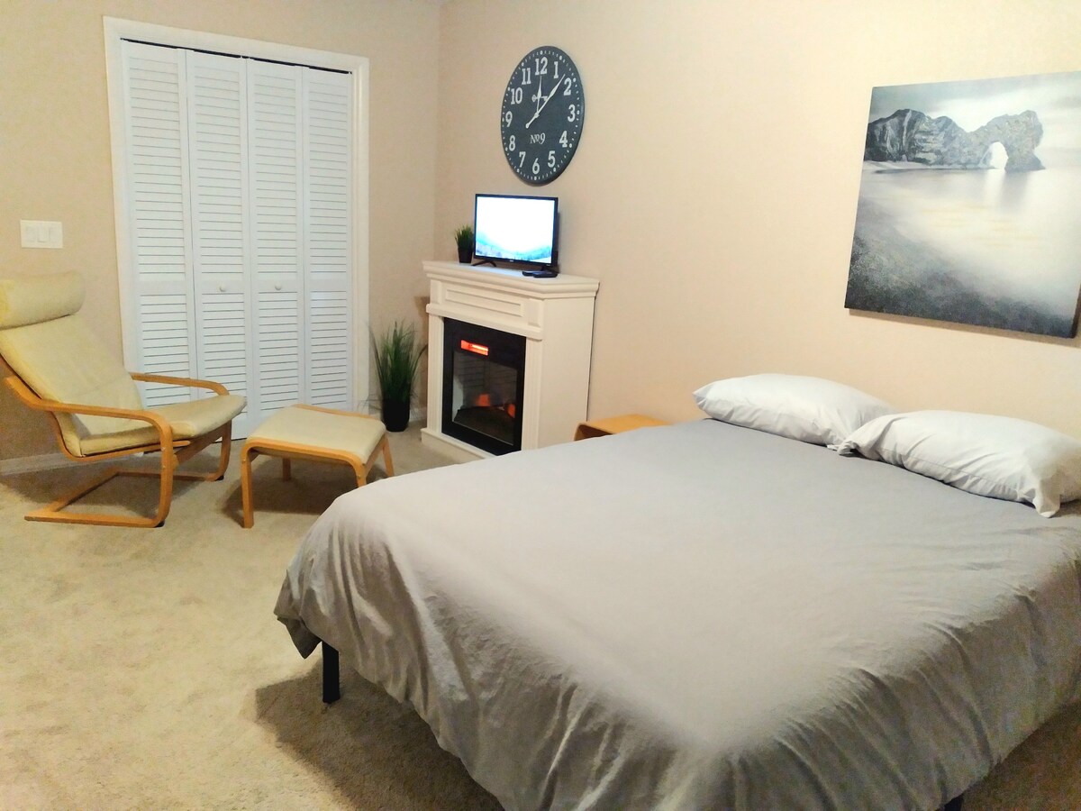 The third bedroom with cozy double bed offers a lounge area with fireplace and HDTV.  With direct access to outside, the ground floor shower, and garage makes this room private, convenient and connected.