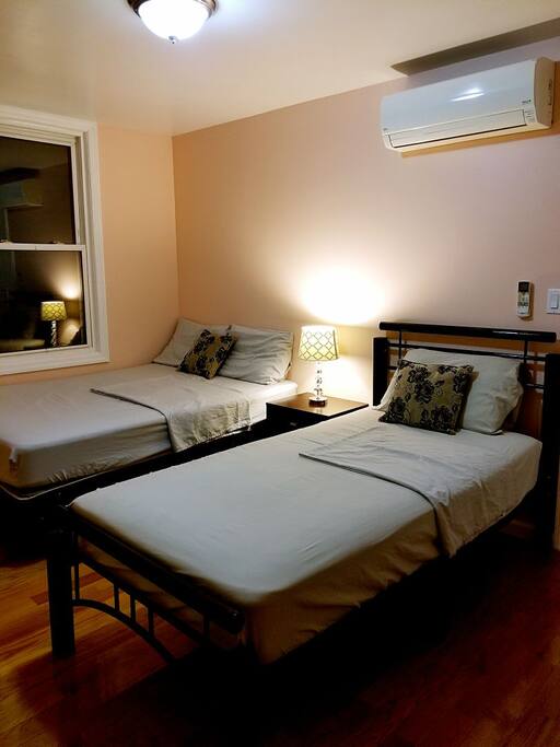 Comfortable full sized and twin sized bed with well decorated working desk and room closet