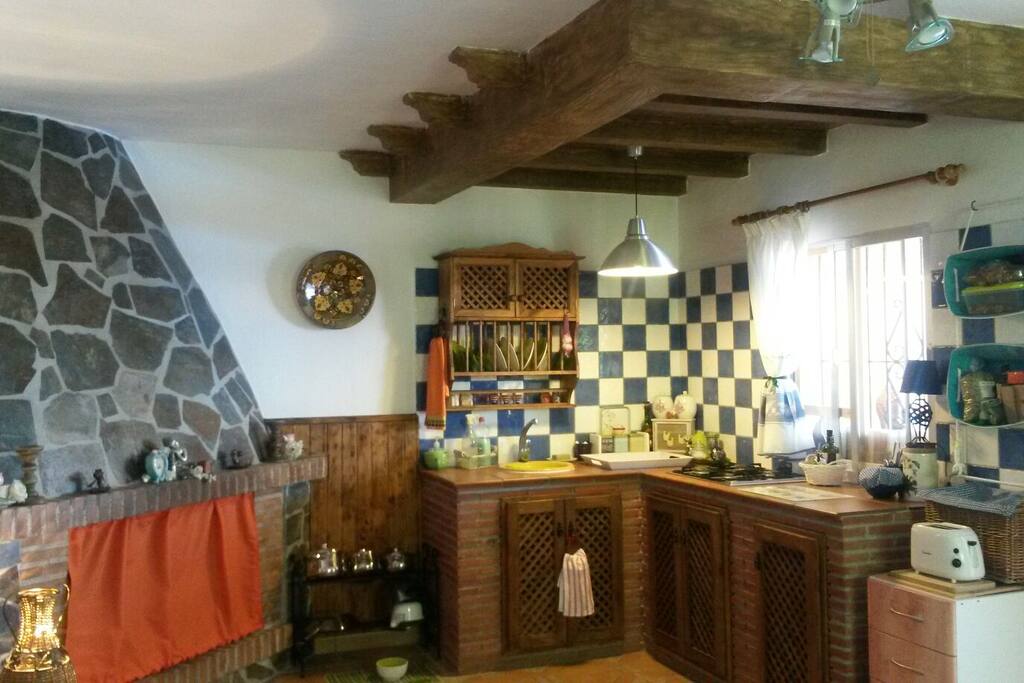 The vibrant cosy kitchen inside the cortijo, you can enjoy the outdoor kitchen and barbeque area!