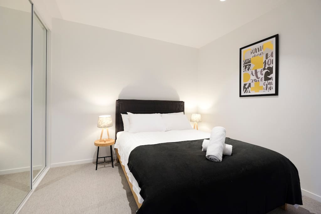 Spacious bedroom with comfy queen bed.
