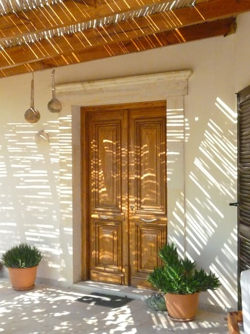 The main wooden door to the house, inside the courtyard, designed by my mother, Sophia.