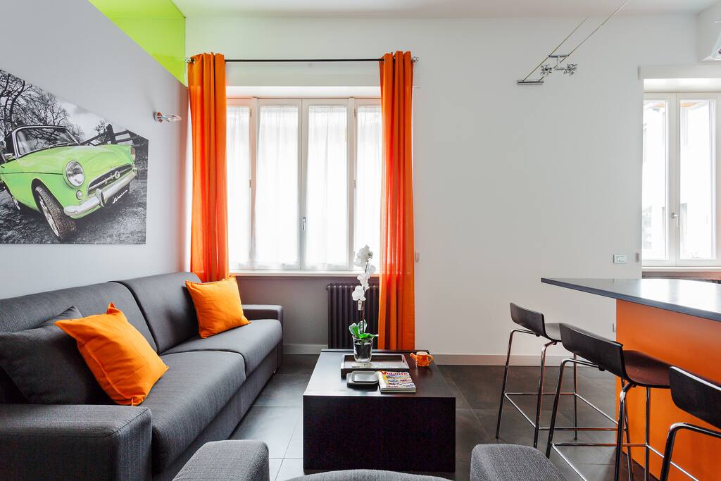 The living room: sofa, dining table, TV, AC
