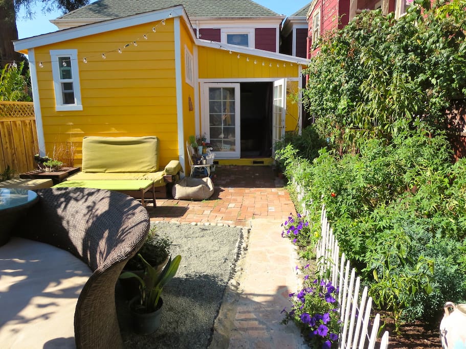 View of the front of the cottage with the gardens lining the path