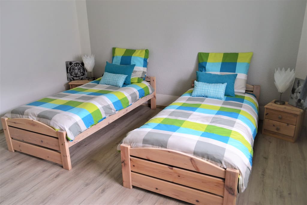 Room 1 - with two single beds, bedside tables and a small closet