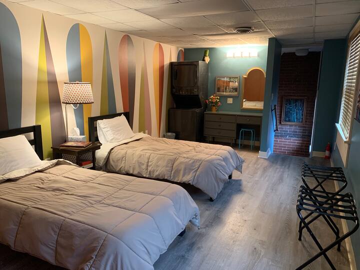 The 2nd bedroom was renovated in November 2019 with a retro mural wallpaper, new flooring, washer/dryer and a cozy feel.  