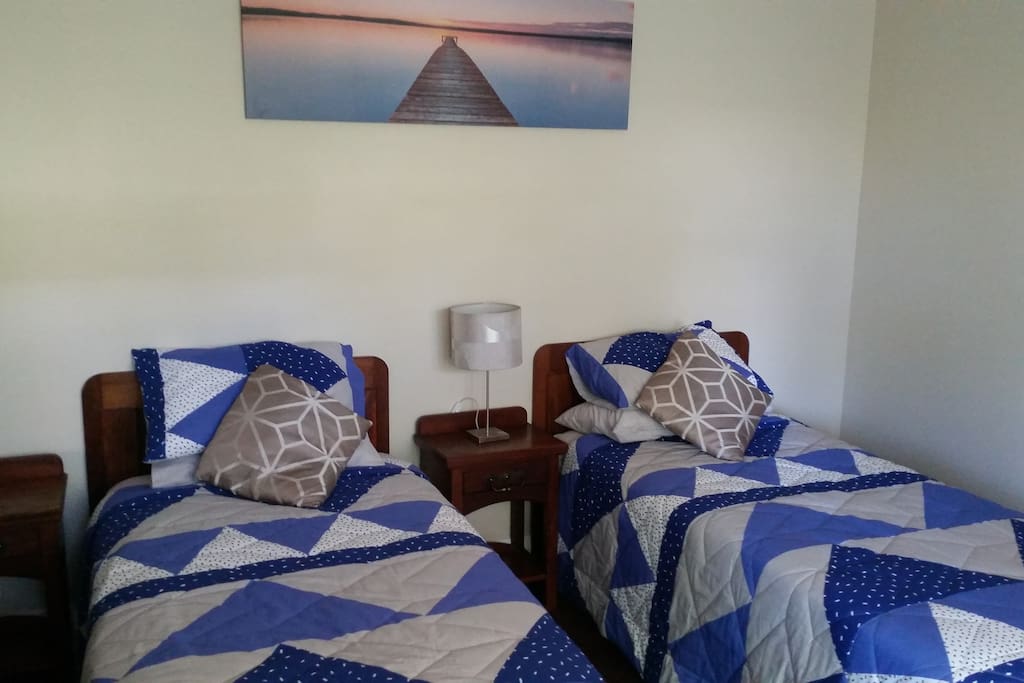 Two King single beds in a spacious, air conditioned, private room.