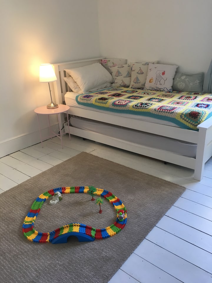 Downstairs bedroom with one bed stowed away making more space as a playroom if required