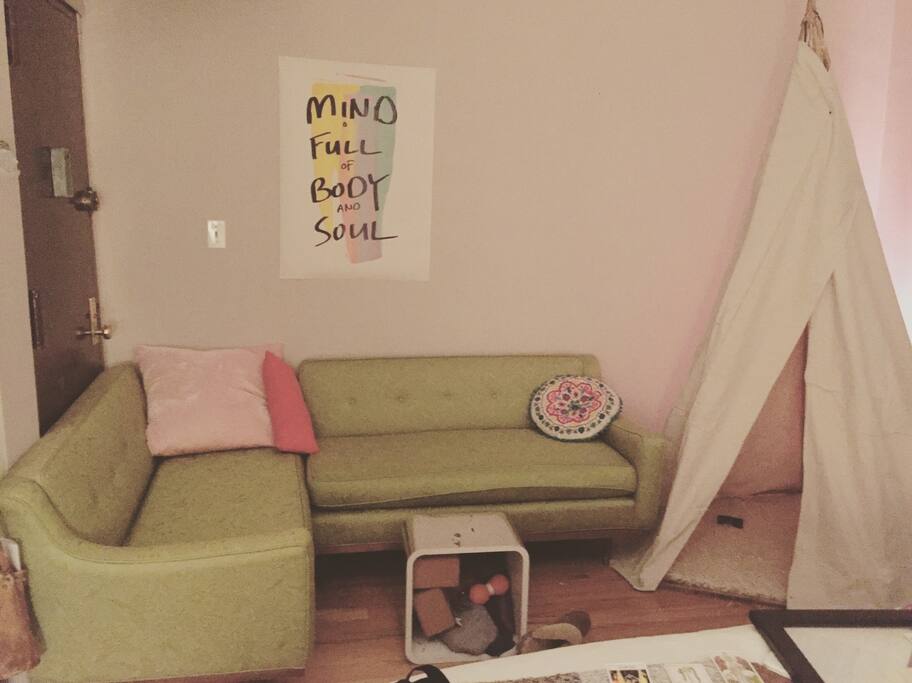 Chartreuse couch to sit on, tipi to sit in.