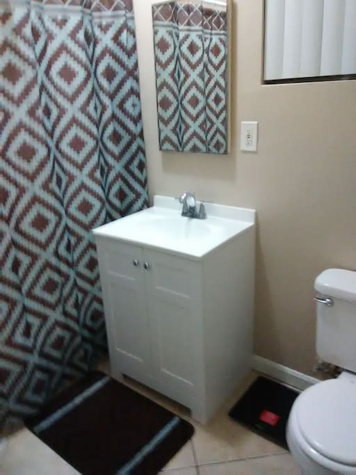 Clean restroom with shower and tub.