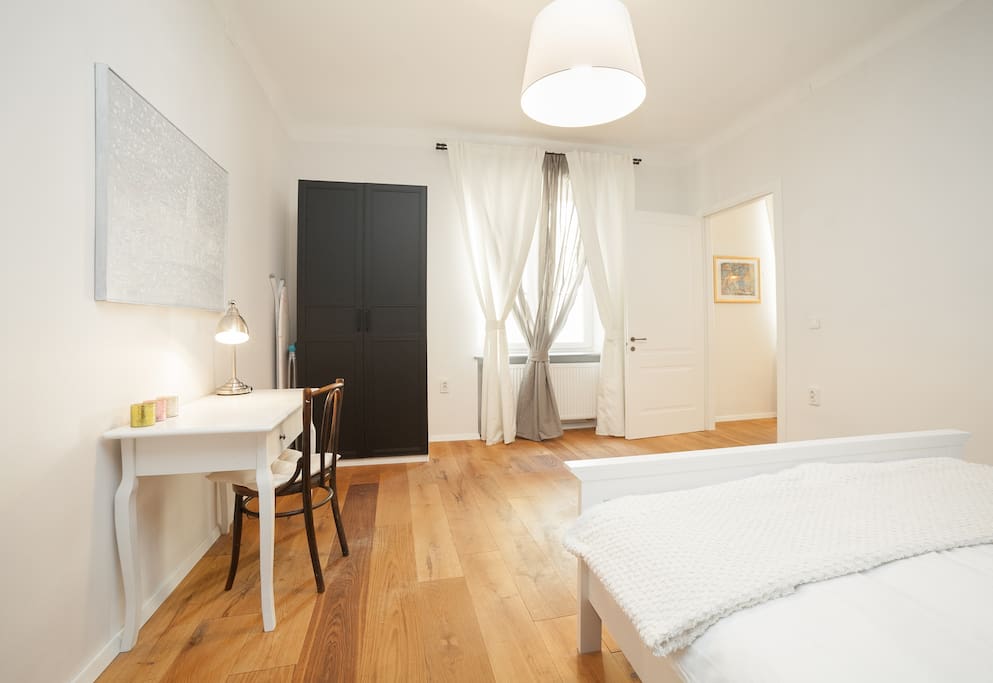 High ceiling badroom with Parisian decor walls, spacious and bright. Big wardrobe to fit all your personal things