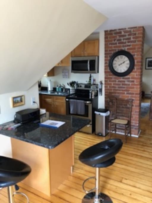 View of the kitchen and breakfast bar from the front door