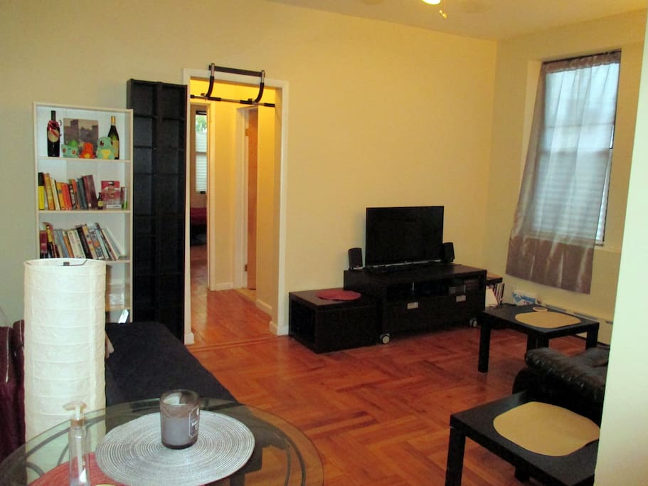 Spacious and comfortable living room with TV, walk-in closet, reclining leather couch (sleeps 1), futon (sleeps 1), music speakers.