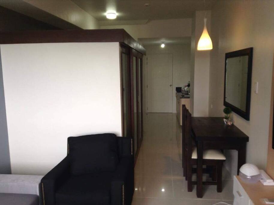 Clean space, easy to move around. This is the hallway view from the main door with the bedroom enclosure on the left and dining table on the right.