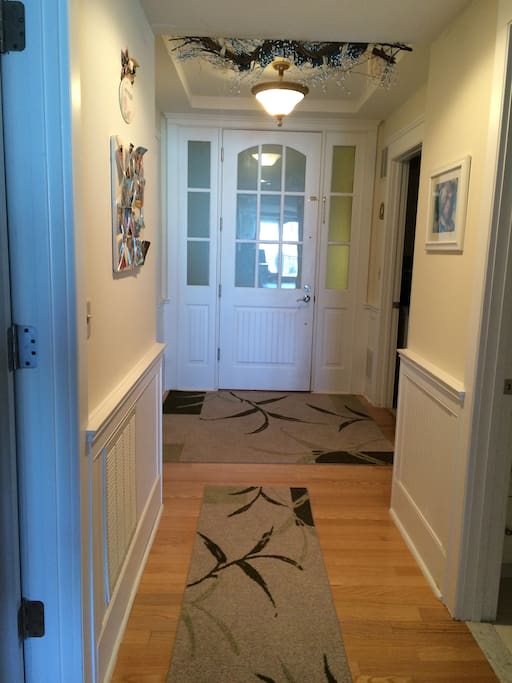 Warm Welcoming Entrance Hallway w/ Laundry Room to Left & Kids Bedroom to Right