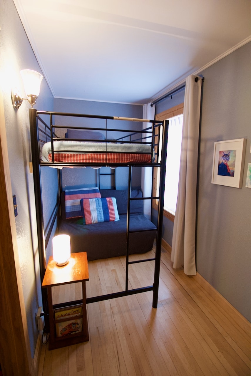 Accordion futon style bed underneath the lofted bunk. Pulls out to full size bed. 
