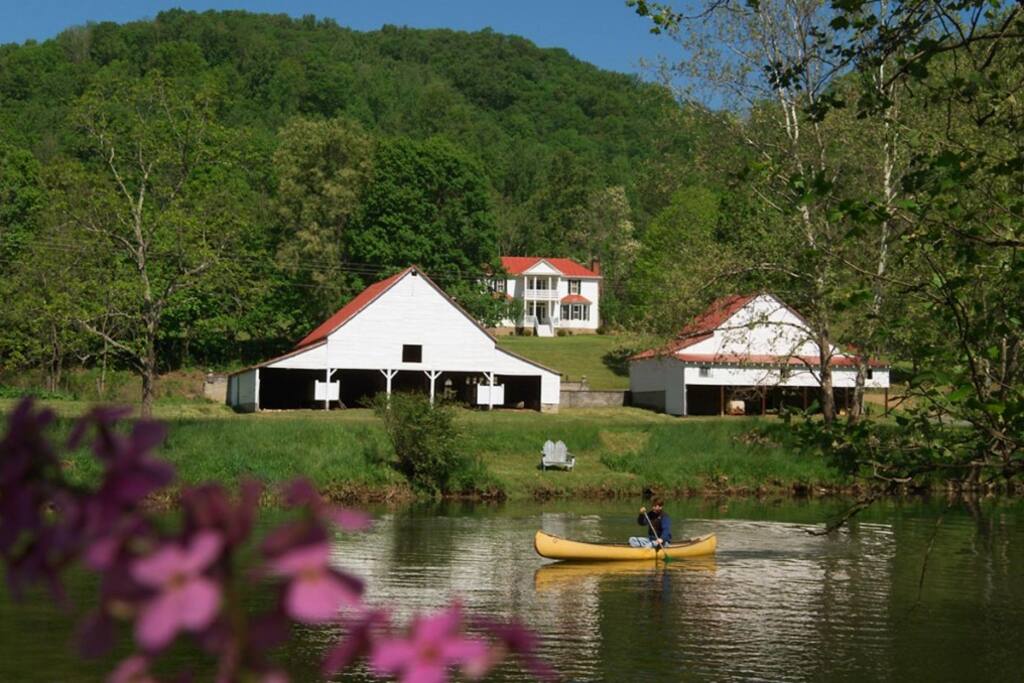 View of the house & 2 nearby barns from the river