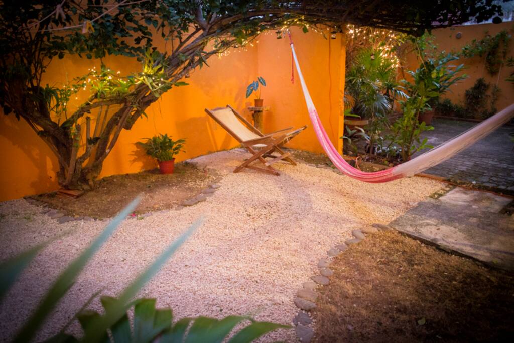 Zona de descanso en patio. Vegetación tropical . Bugambilia, orquideas y bromelias.