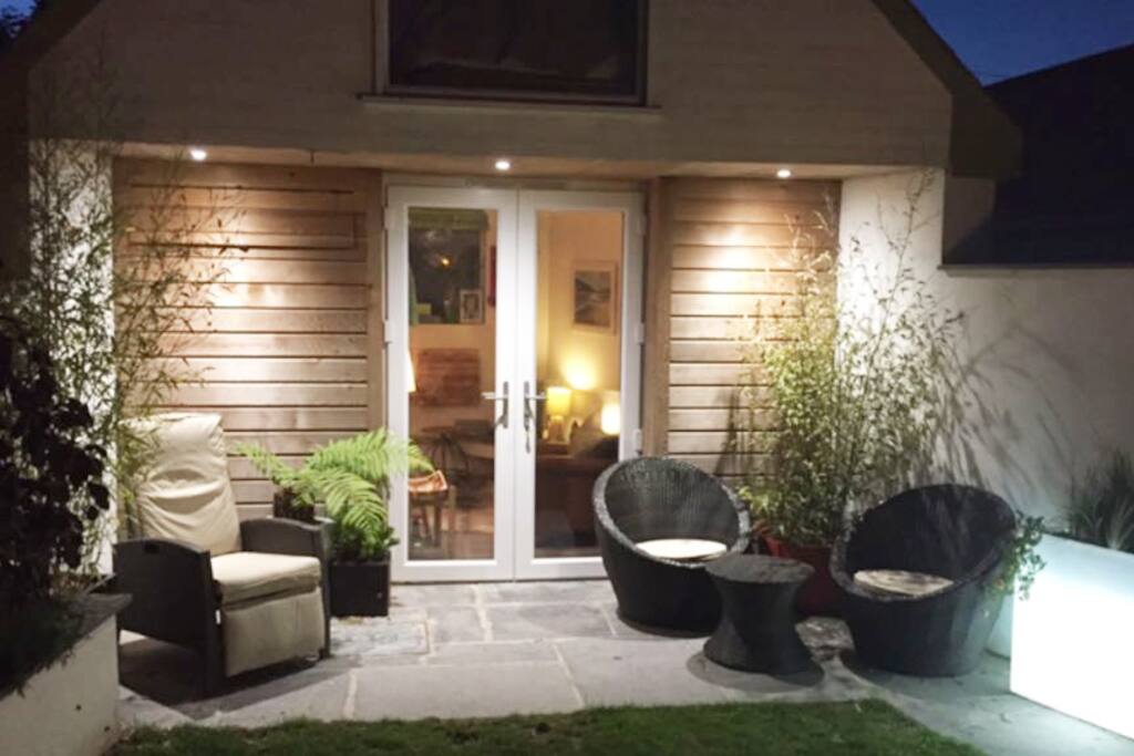 Tasteful lighting in the garden make this a lovely place to sit out in the evening.
