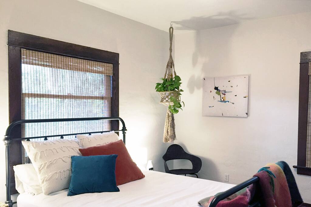 Your cozy bedroom with comfy queen bed, fine art, and bohemian botanicals!