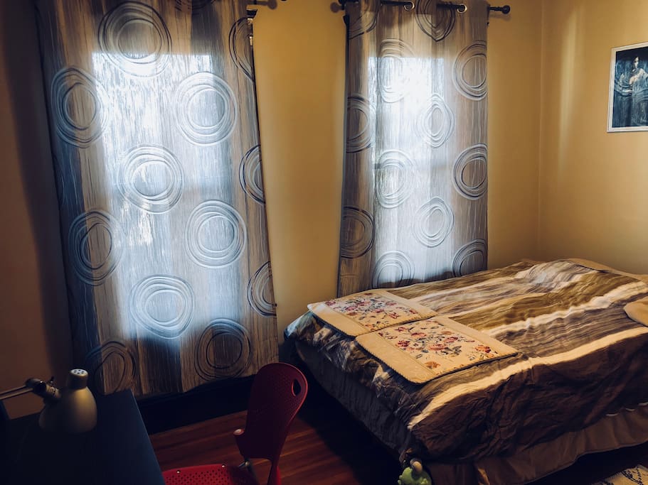 Bright guest bedroom with desk