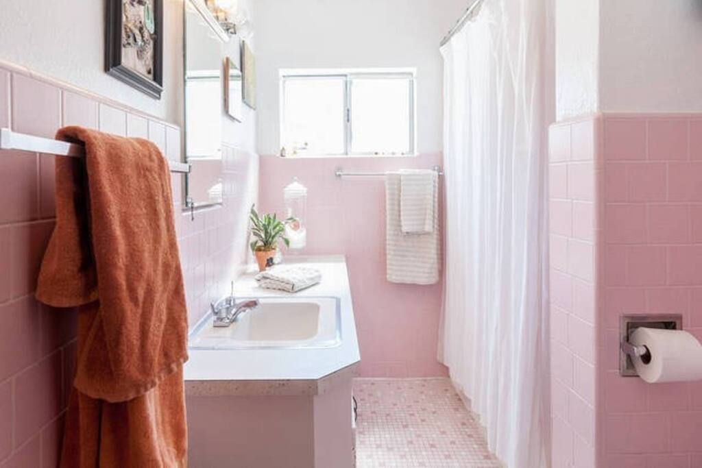 Clean, pink bathroom.