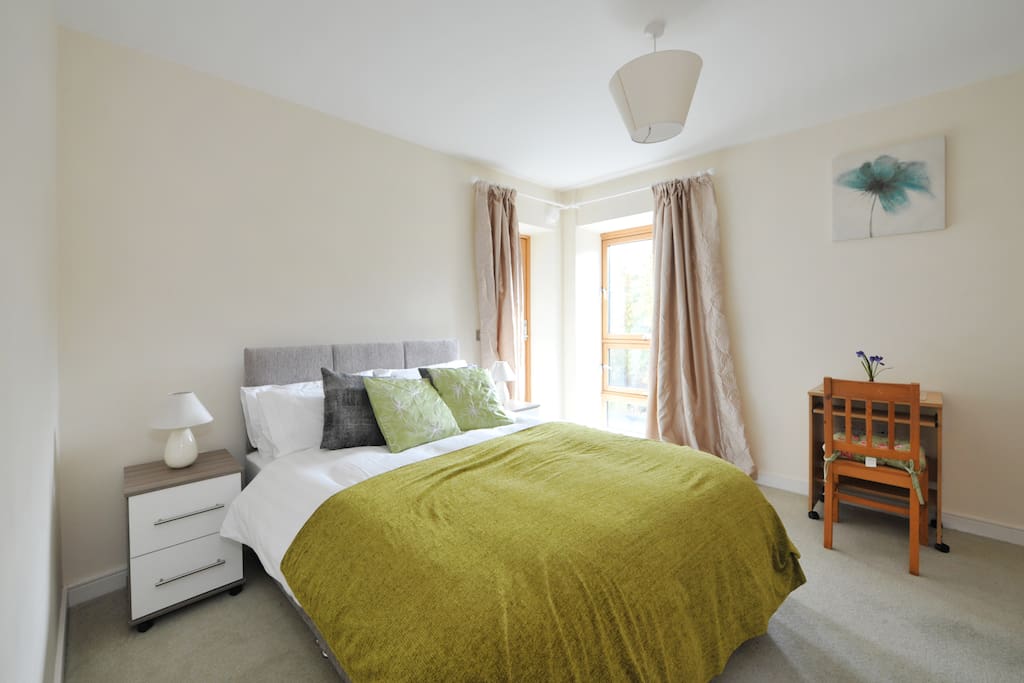Spacious double bed with access to the balcony