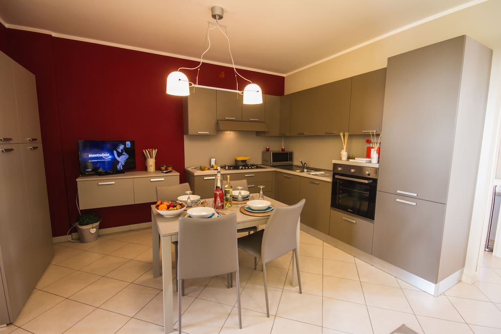 Fully fitted modern kitchen with a dishwasher and a dining set