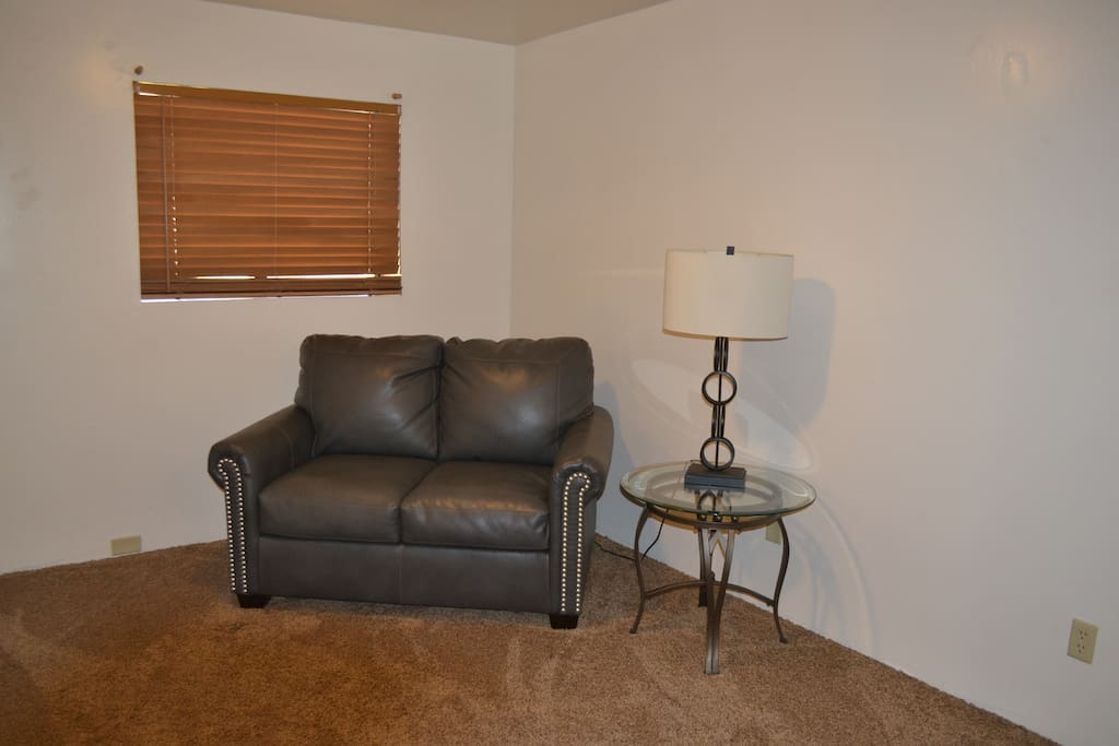 Sitting area in Master Bedroom. Loveseat folds out into twin size bed.