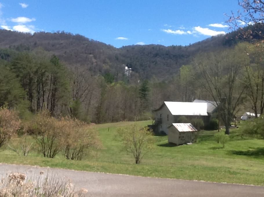 Your view of the Blue Ridge mountains and Estatoah Falls as you relax in a rocker on the spacious porch. The quaint farmhouse in the foreground adds to the serenity of your view.