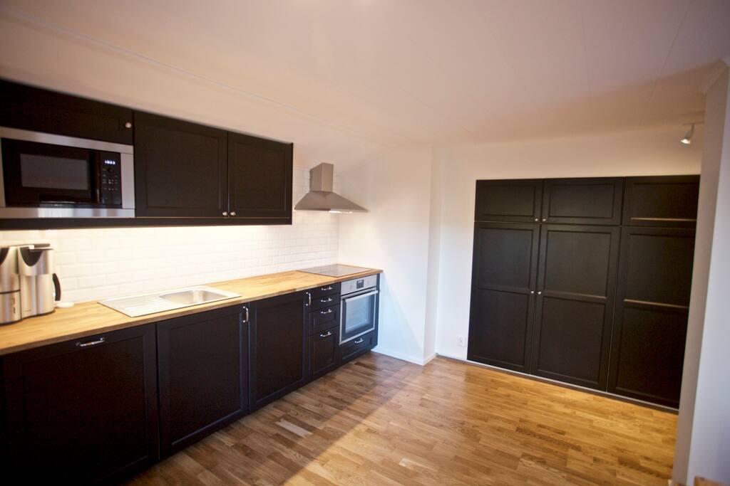 Newly renovated kitchen including dishwasher, microwave, coffee machine, waffle iron and more.