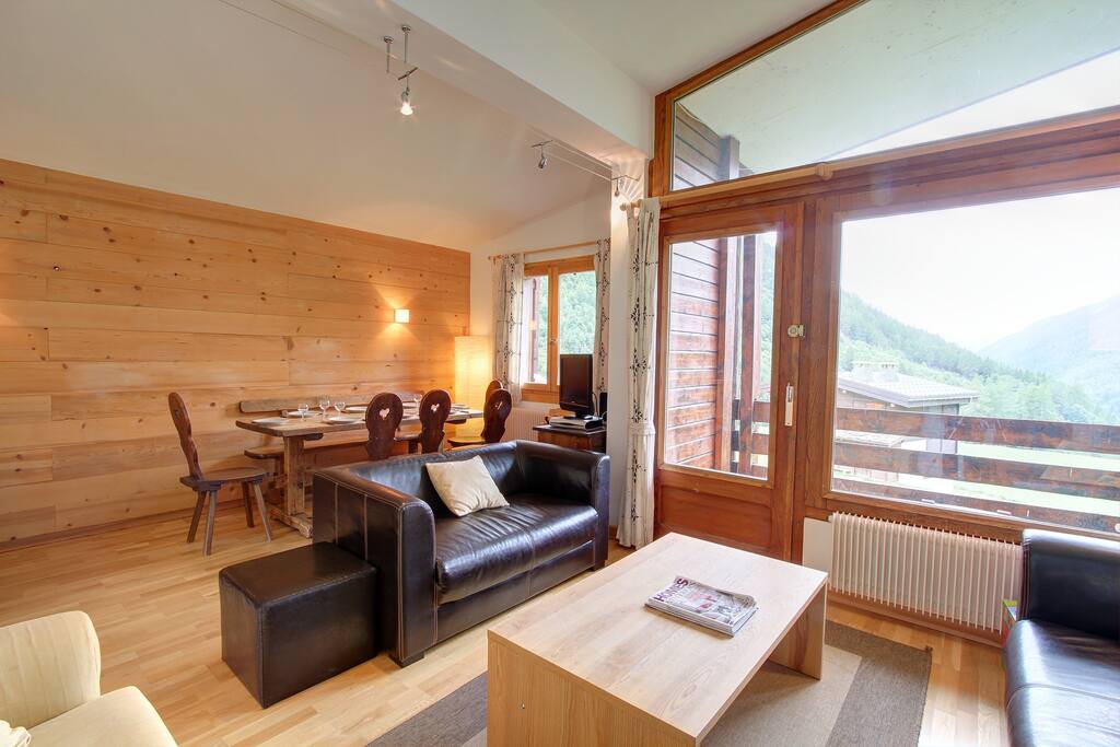 Lounge with dining area in the background.