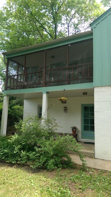 Front of the house with a screened-in front porch.
