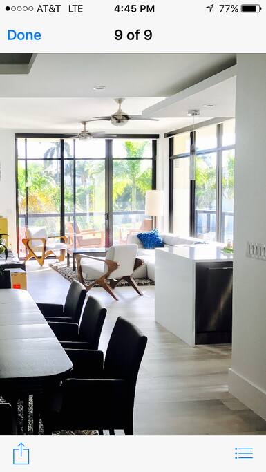 Great room with floor to ceiling windows looking at canal