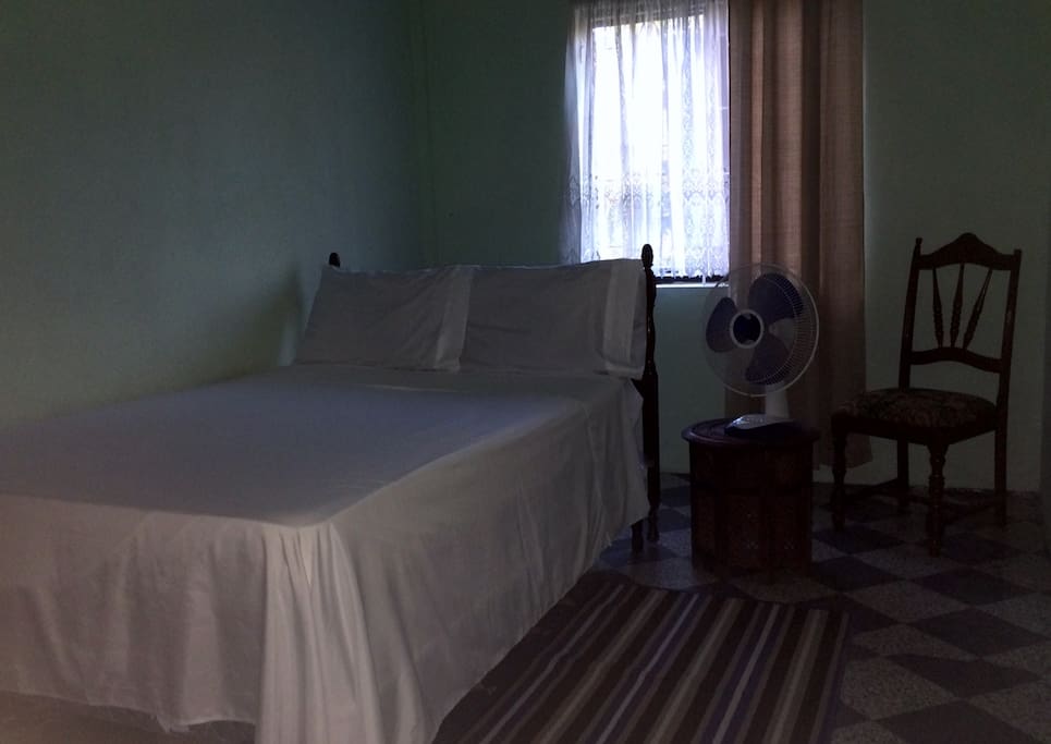 Your room awaits with mosquito screens and fan