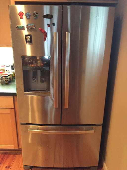 Stainless steel refrigerator with an ice machine and freezer. Food is not included