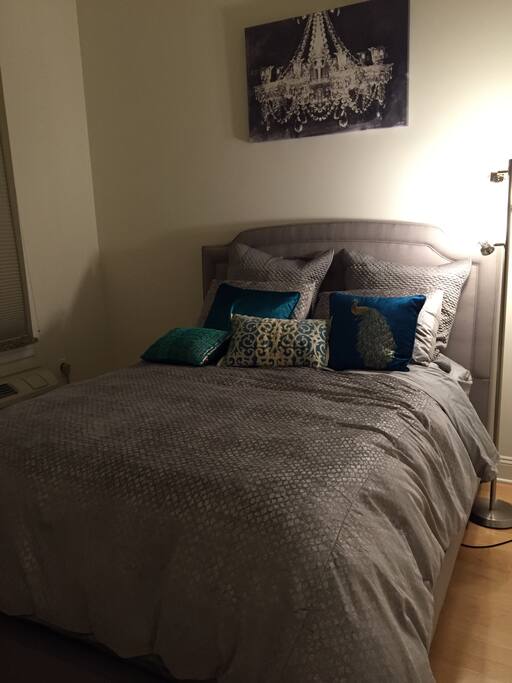 Spacious bedroom with large bedroom window and lots of sunlight
