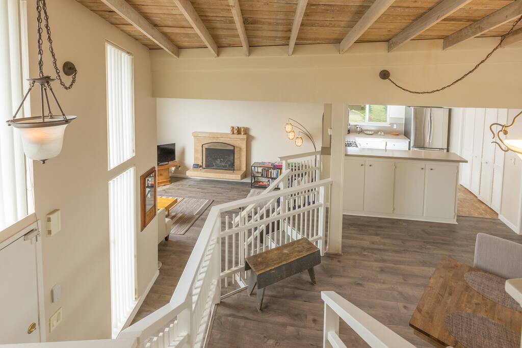 View from upper bedroom; dining room / kitchen level and down to living room.