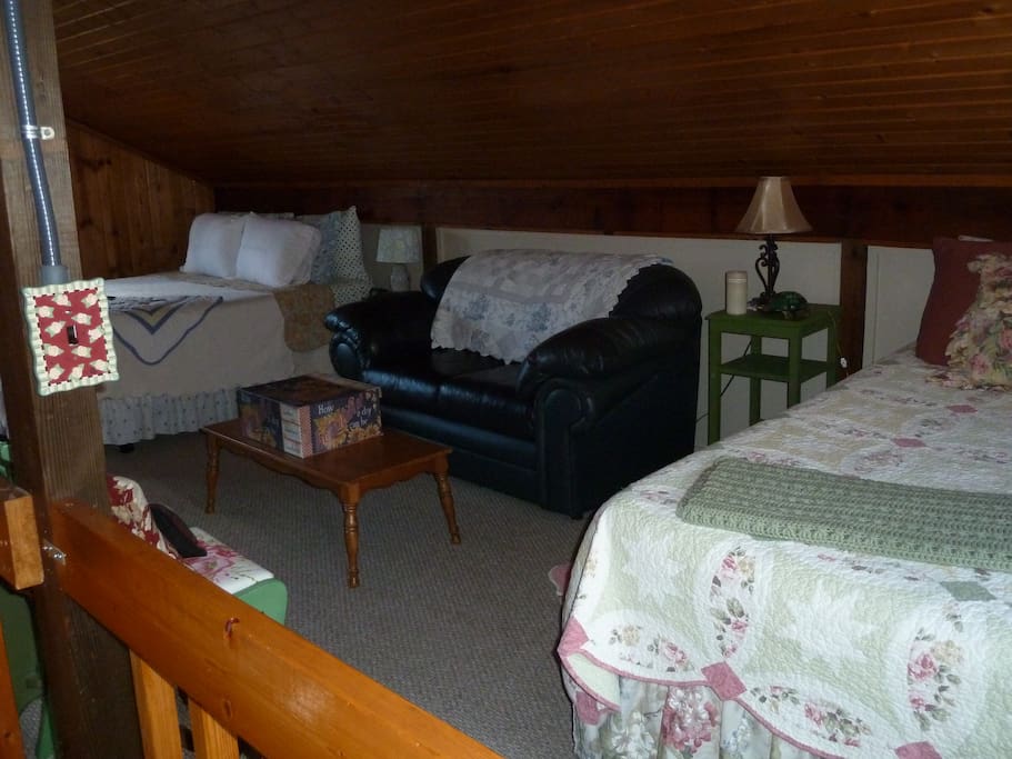 lofted bedroom with two queens and one full bed