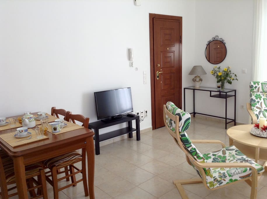 The inside of the house with details from the living room, the dining room. and the outer door.