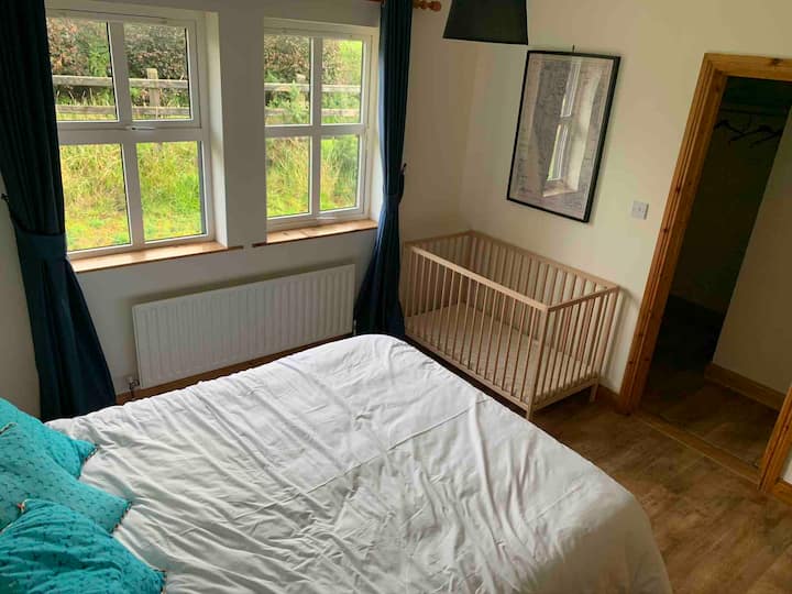 Ground floor double room with king size bed and walk in wardrobe and cot