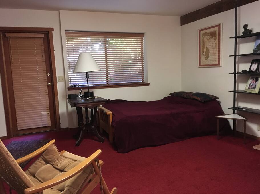 Comfortable bed, bookshelves, and rocking chair