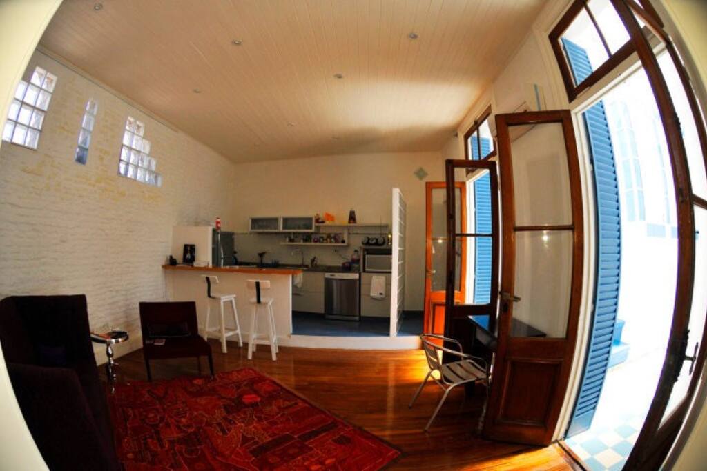 Open kitchen with breakfast bar, dishwasher, microwave, fridge, full of sunlight and air