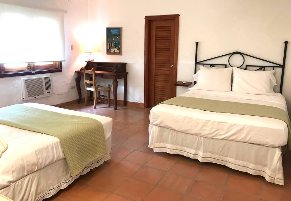 Garden Bedroom - two queen size beds, door to walk in closet and en suite bathroom