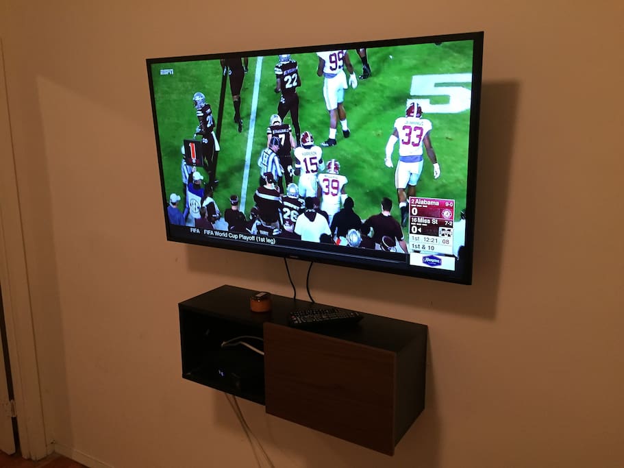 Mounted 50 inch Smart TV with cable