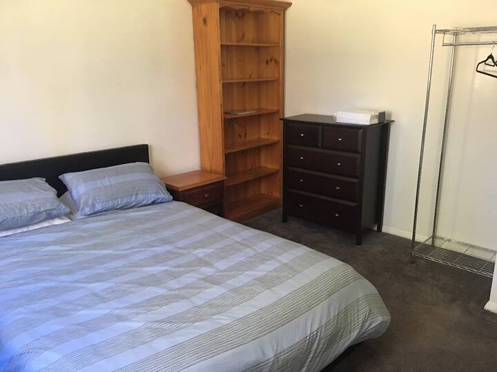 Very comfortable Queen bed with doona 4 pillows and an additional blanket in case you get cold.
There is a hanging rack and some coat hangers provided, chest of drawers, bedside tables with reading lamps. Great for longer stays.