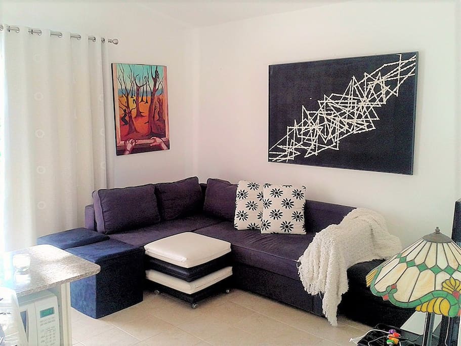 The livingroom of the apartment comes with a balcony, open kitchen, seating area, WIFI, AC and TV