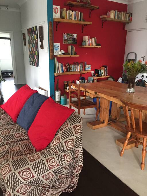 Lounge to dining area and bookshelf.